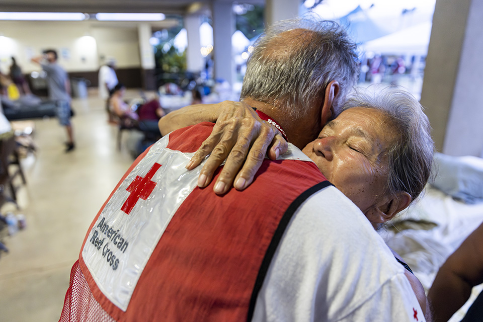 Red Cross volunteers assist wildfire victims at a shelter in Wailuku, Hawaii.
