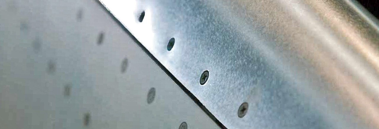 Close up of screws in sheet metal