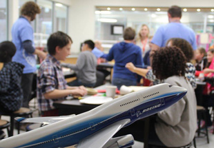 Teachers and student in classroom.