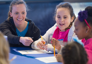 Teacher interacting with students.