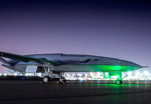 Picture of M Q-25 on runway at night.