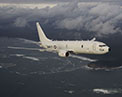 Picture of P-8 A in flight over coastline.
