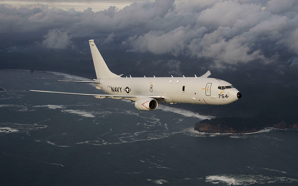 Picture of P-8 A in flight over coastline.