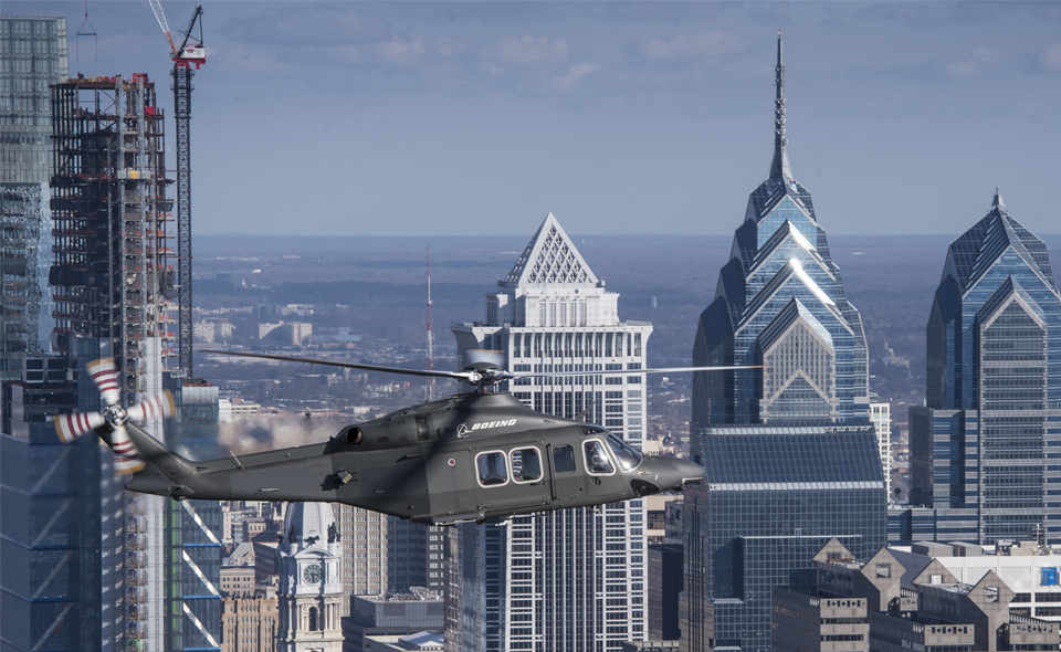 MH-139 in flight over city.