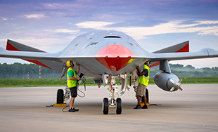 Picture of MQ-25 and personnel.