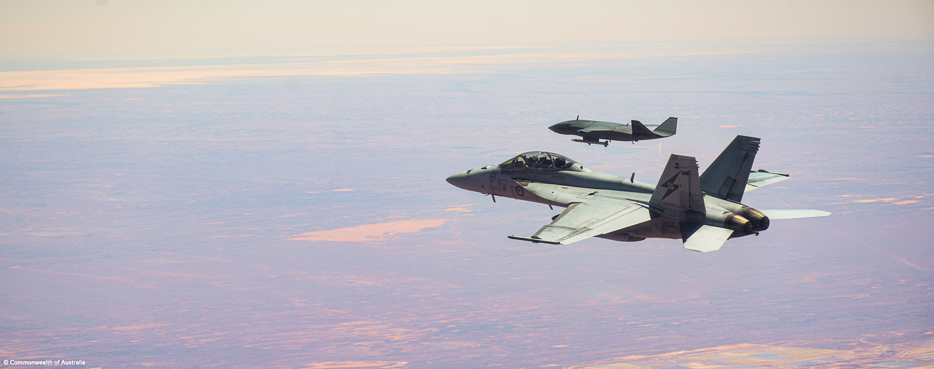 MQ-28 Ghost Bat teamed in flight with F/A-18F Super Hornet