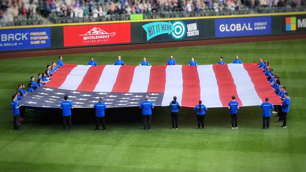 Puget Sound chapter of the Boeing Veterans Engagement Team presenting the flag at the Mariners Salute to Armed Forces Night.