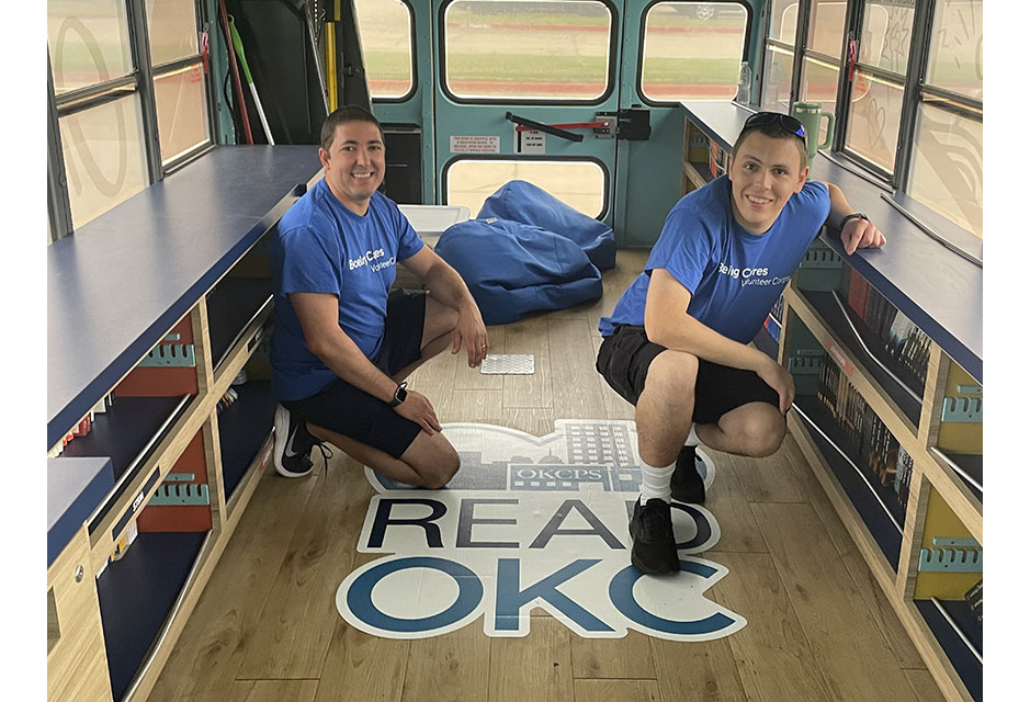 Chris Silvano (right) and Oklahoma City teammates pack books onto buses with Boeing partner ReadOKC. The Book Buses visit Oklahoma City Public Schools, allowing students to select a book of their choice to add to their home library.
