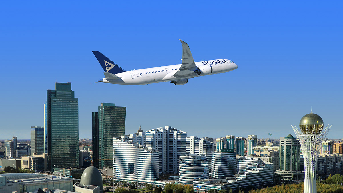 Air Astana 787 flying over city scape