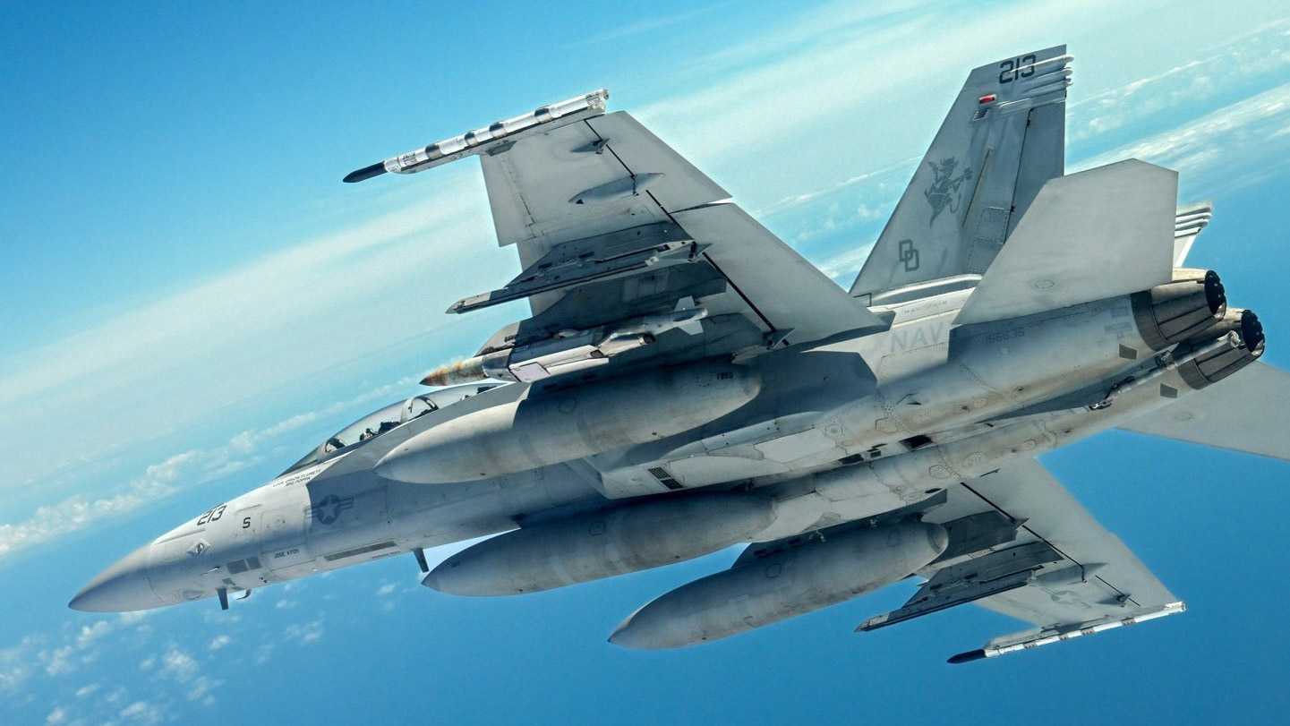 An F/A-18 fighter carries a JDAM Long Range during a flight test