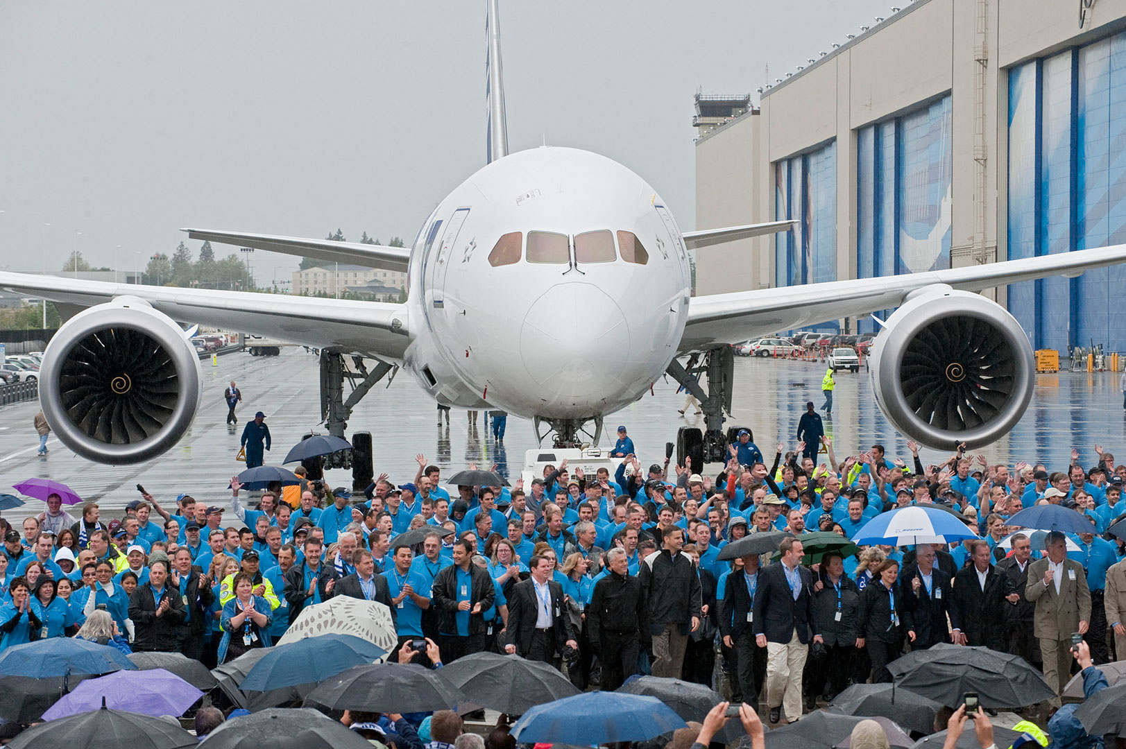 Employees walk alongside the first 787 Dreamliner delivered in 2011 to present it to launch customer ANA.