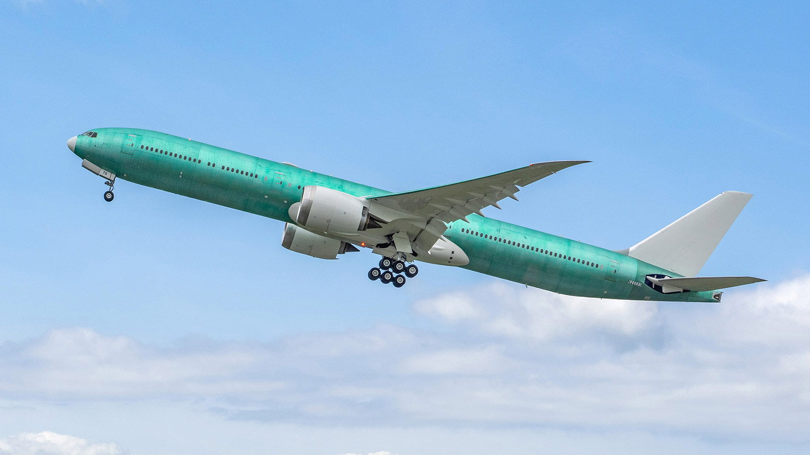 Boeing 777-9 is shown taking off from an airport