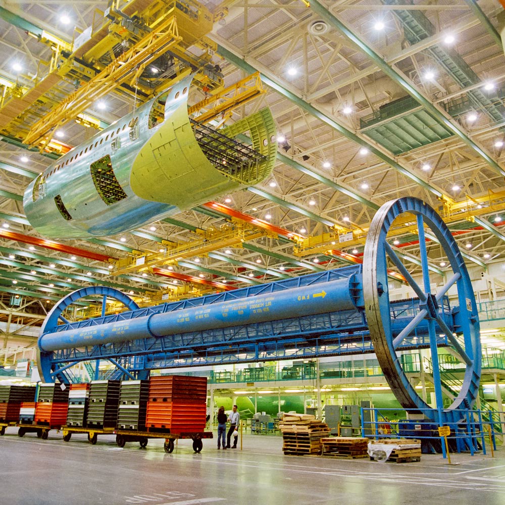 The partially built assemblies were then craned into a massive turn tool to rotate them upright, then craned back to complete assembly. This method was replaced by determinant and upright assembly, which improved workplace safety and quality.