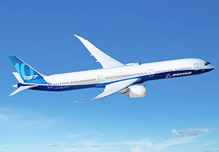 A Boeing 787-10 Dreamliner soaring through a clear blue sky.