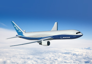 767 in flight over clouds.