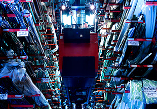 A view of a parts storage facility, showcasing organized shelves filled with aircraft components and materials.