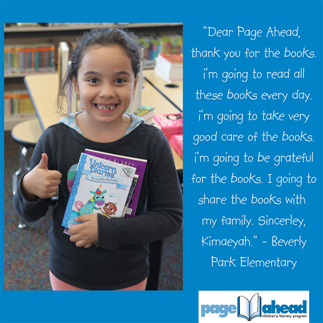 Girl giving thumbs up while holding books.