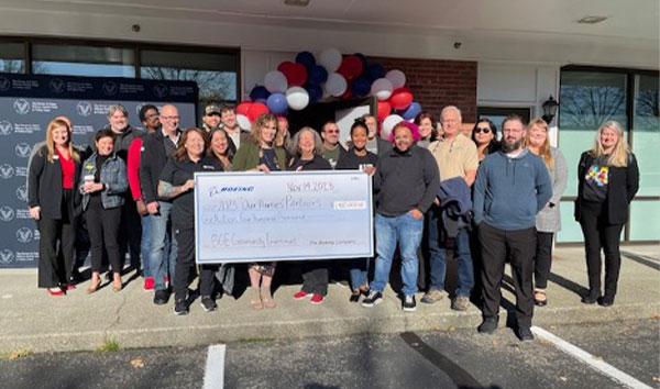 Officials display a check for $1.4 million