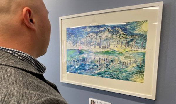   A visitor looks at artwork from a military veteran