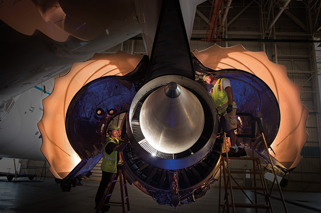 Mechanics working on an engine.
