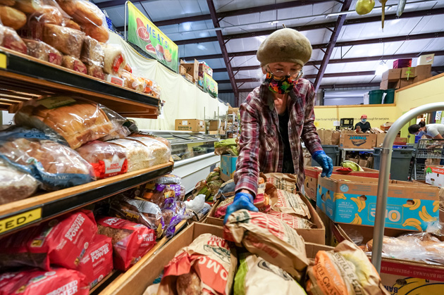 Volunteer prepares food at Ballard Food Bank.