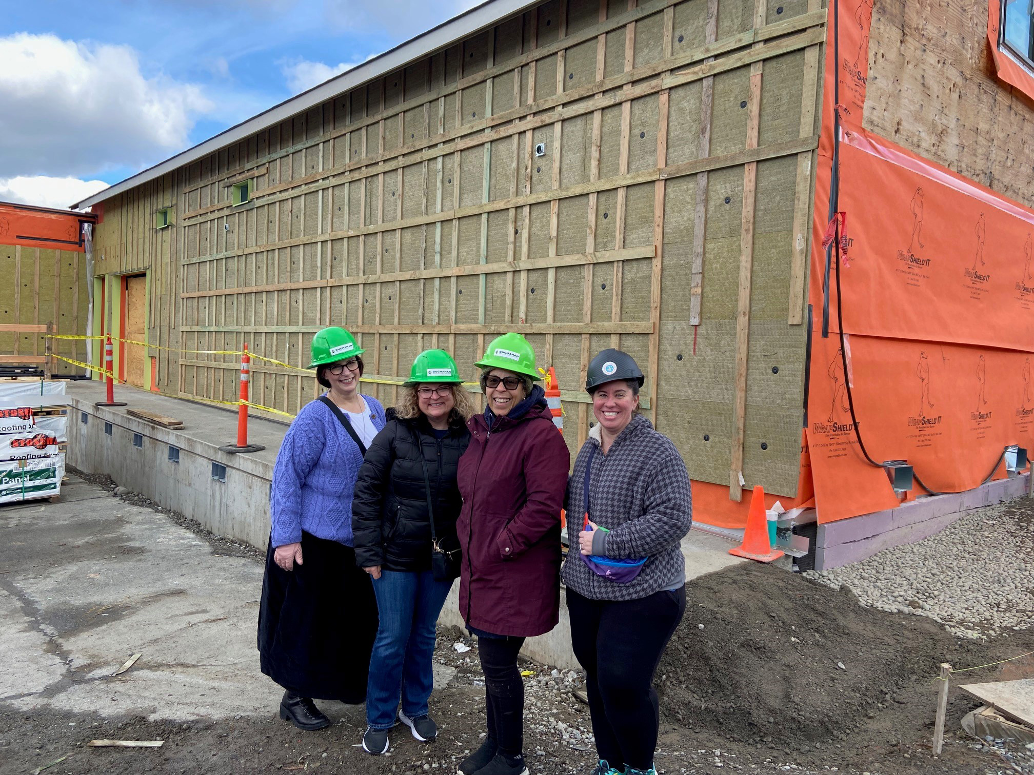 Four individuals in front of construction site