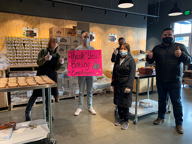 Northwest Harvest employees holding thank you sign.