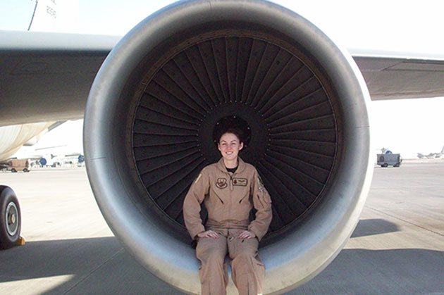 Staff Sgt. Danielle Hughes Crone sits in the engine of KC-135.