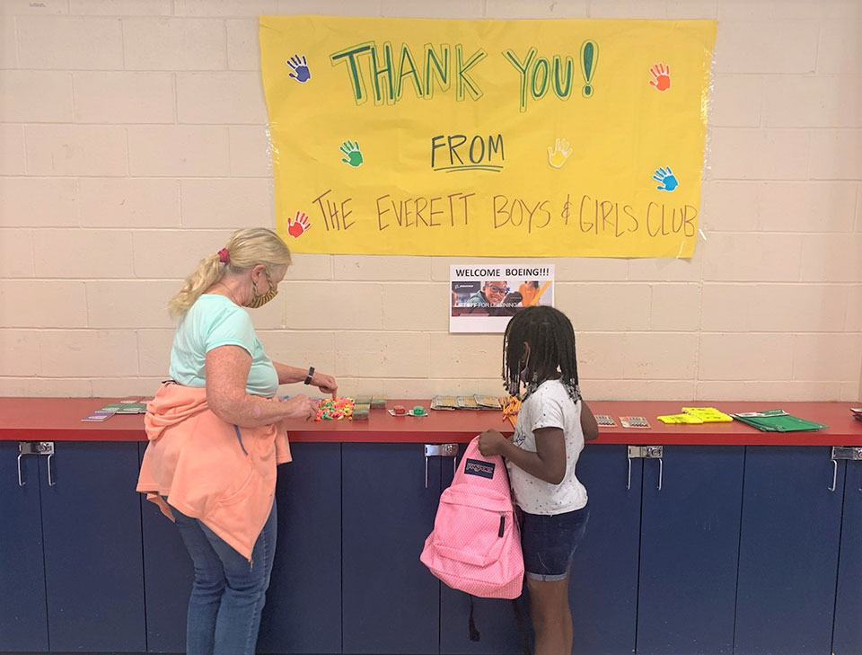 A volunteer provides school supplies to a student at the Everett Boys & Girls Club.