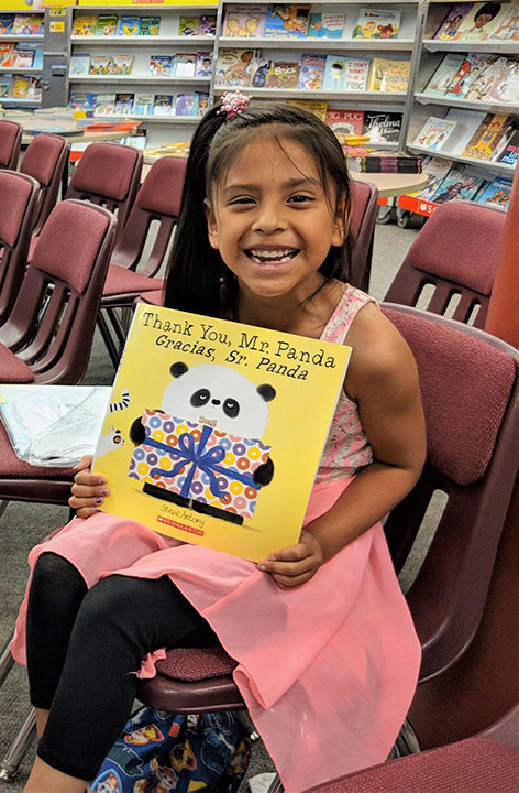 Student who received new books from Page Ahead.