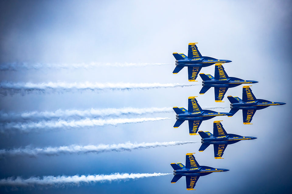 The U.S. Navy Blue Angels demonstrate their precise skills as they fly their F/A-18 Super Hornets over Seattle. The F/A-18 Super Hornets are Boeing made, and Boeing handled all the modifications to turn the Super Hornets from combat fighters in the Navy fleet to demonstration jets.