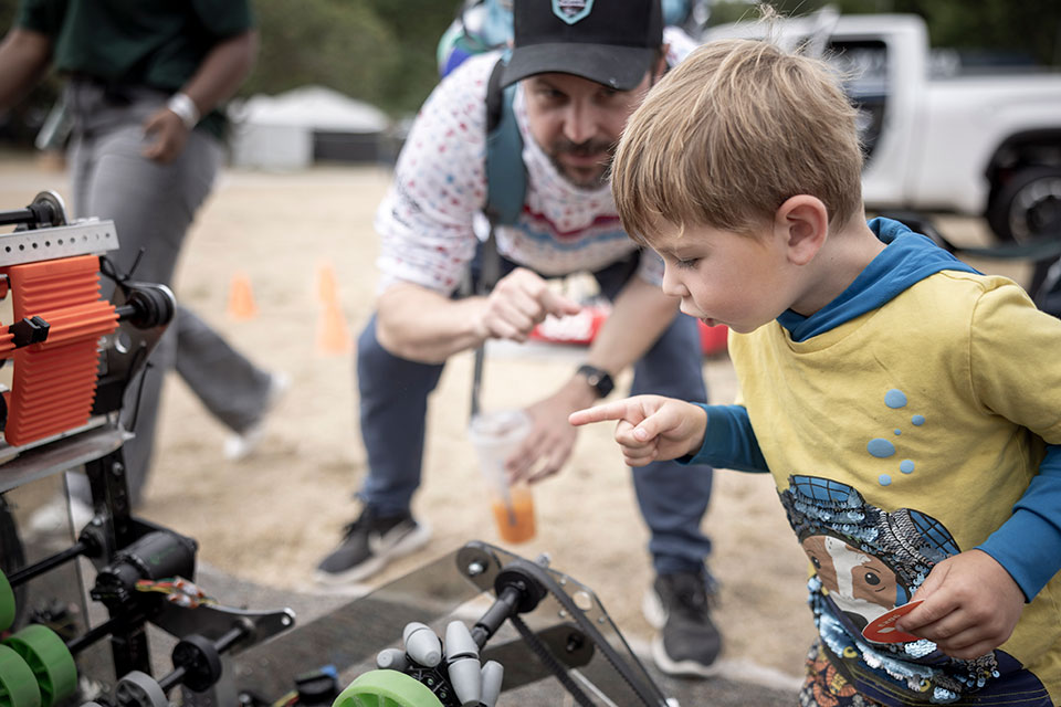 A child checks out a robot fully constructed by students from a FIRST Robotics Team from Skyline High School in Sammamish, Washington.