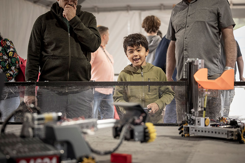 A child drives a robot designed, built and programmed by students from a FIRST Robotics Team from Maywood Middle School in Renton, Washington.