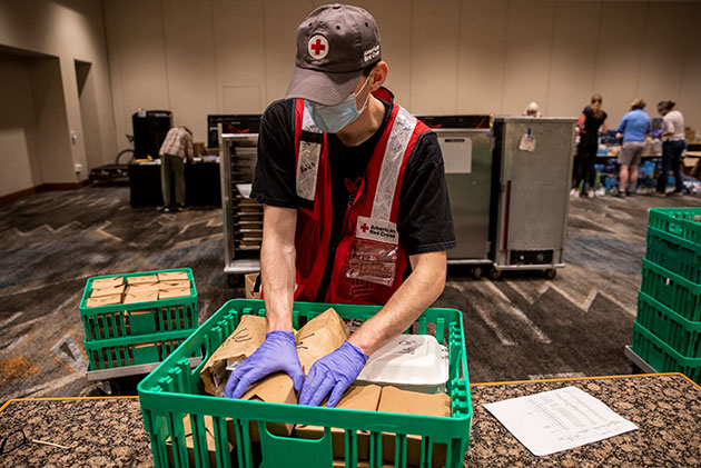   An American Red Cross volunteer helps get meals ready to deliver to evacuees from wildfires on the West Coast.