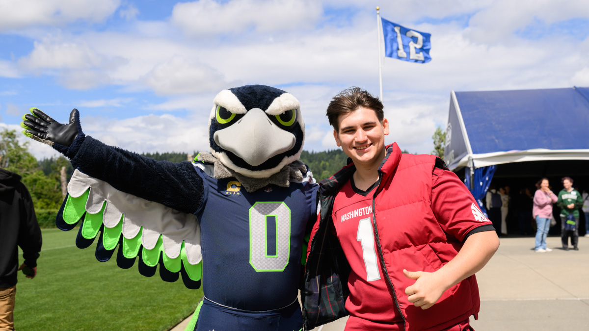 Mascot Blitz poses with student STEM signing day