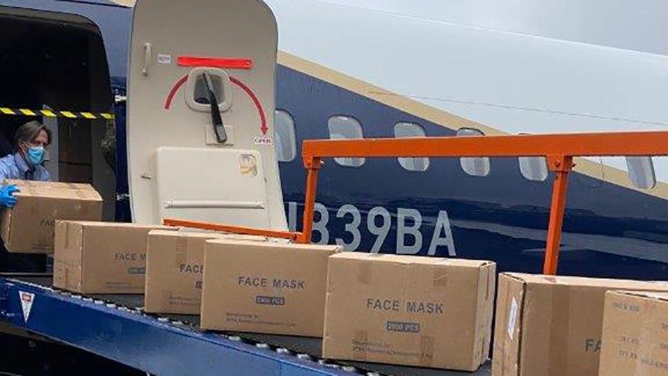 PPE in boxes being loaded on plane.