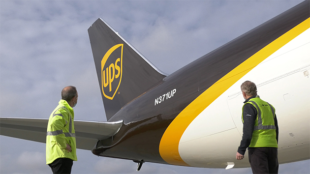 2 pilots standing by a UPS freighter.