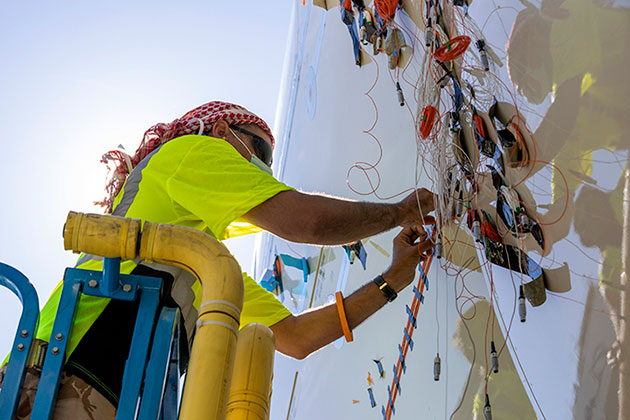 Worker attaching microphone to ecoDemonstrator.