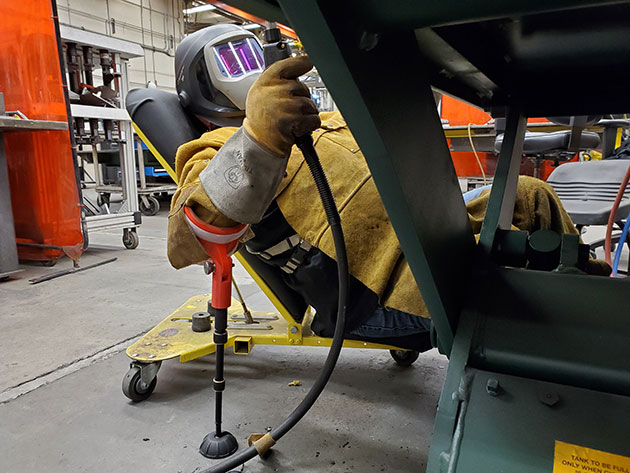 Welder demonstrating improved ergonomics.