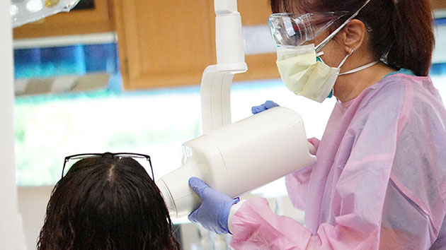 Woman taking x-ray in mobile dental clinic.