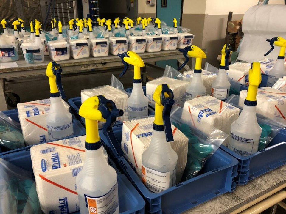 Boeing has implemented several changes at its sites to reduce the risk of COVID-19 in the workplace. This includes enhanced cleaning of high-touch surfaces and collaboration with employees to keep common areas clean. Shown here, at the Boeing Everett site, kits of cleaning supplies have been prepared for employees to use in break rooms, at shared work stations and other common areas.
(Cleaning Kits in the ESRC)