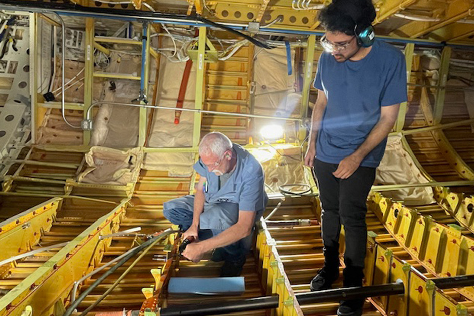 Facilitator Brian Wilson trains student Luvji Singh. (Boeing photo)