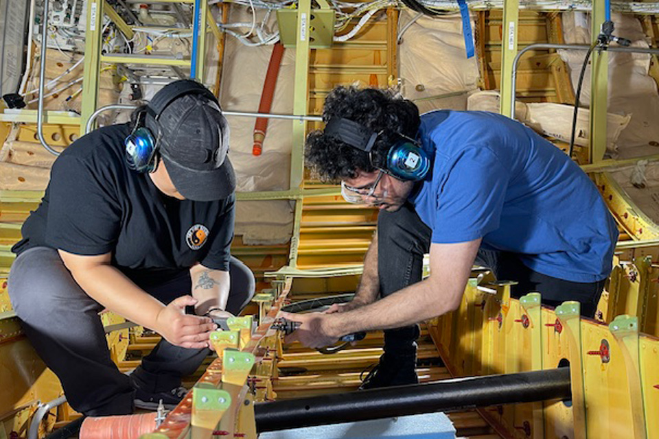 Students Amy Y-B and Luvji Singh getting hands-on training in the fuselage. (Boeing photo)