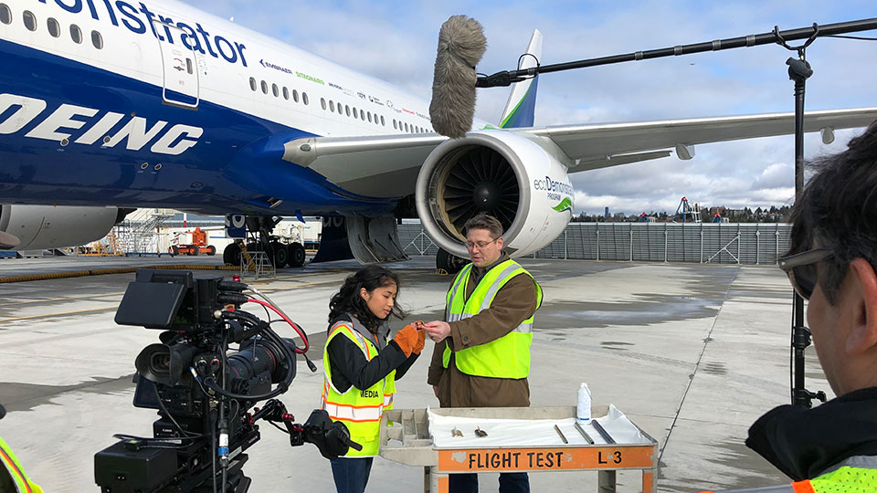 Associate Technical Fellow F. Tad Calkins demonstrates an airplane part that moves based on changes in temperature.