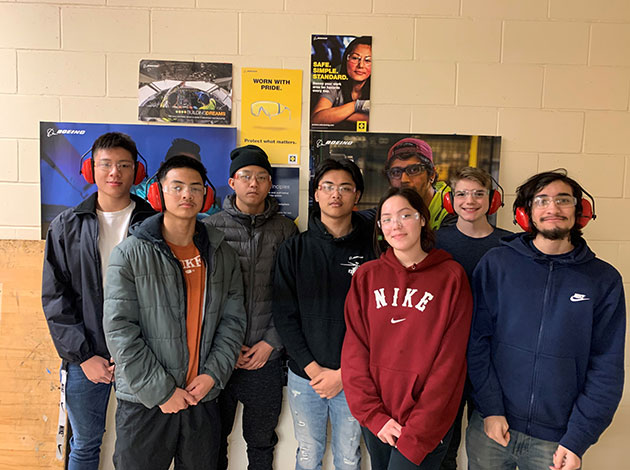 Students from Renton High School display safety equipment provided with the safety kits.