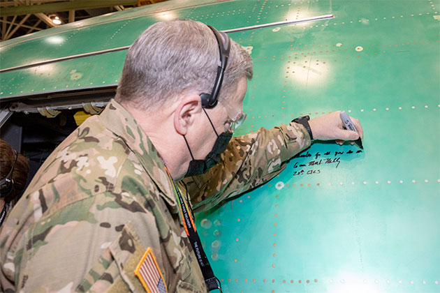 Milley signs the side of a KC-46A tanker