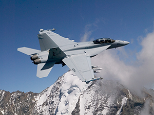 jet flying in front of snow colored mountain