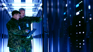 HardwareWall Mission Security - 2 workers looking at mainframe