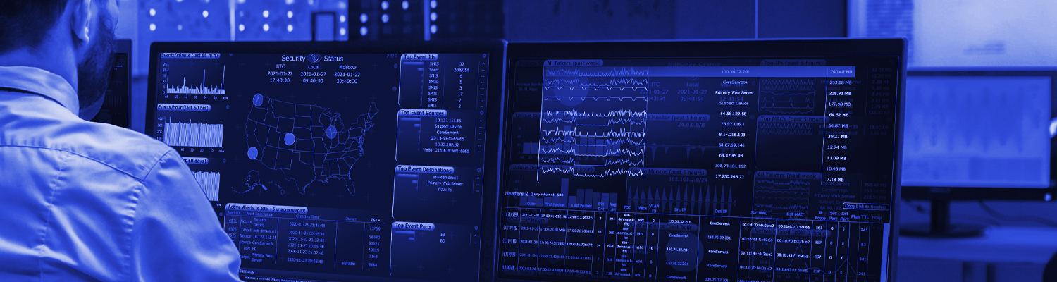 Two computer screens with data flowing across them