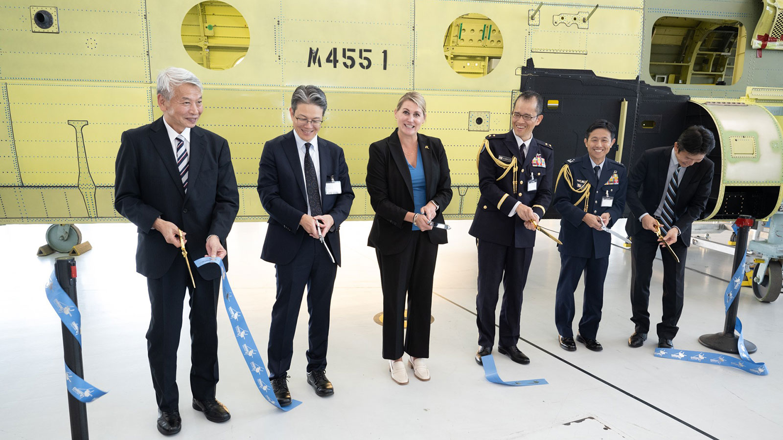 Boeing, Kawasaki Heavy Industries and Japan Ministry of Defense officials participate in a ribbon cutting ceremony to kick off the first JAX aircraft final assembly load.